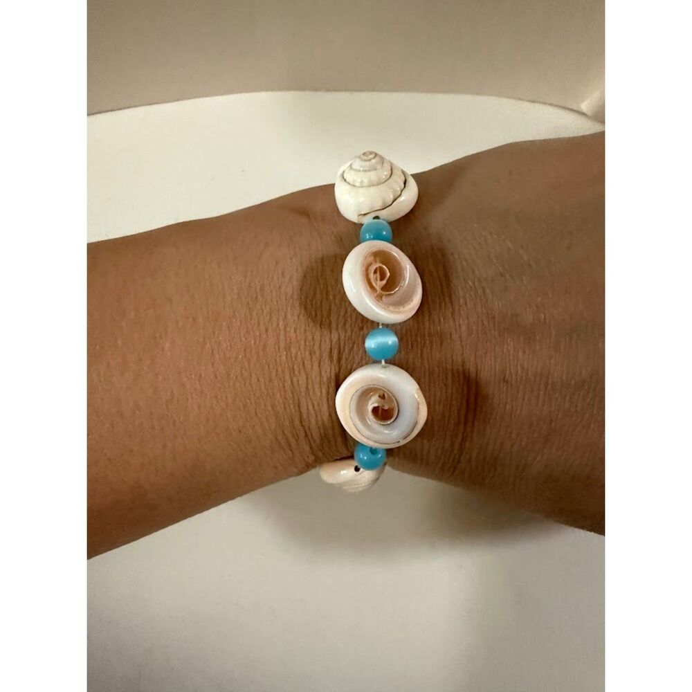 natural coiled shells paired with turquoise-colored beads.